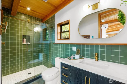 a bathroom with a sink mirror toilet and shower