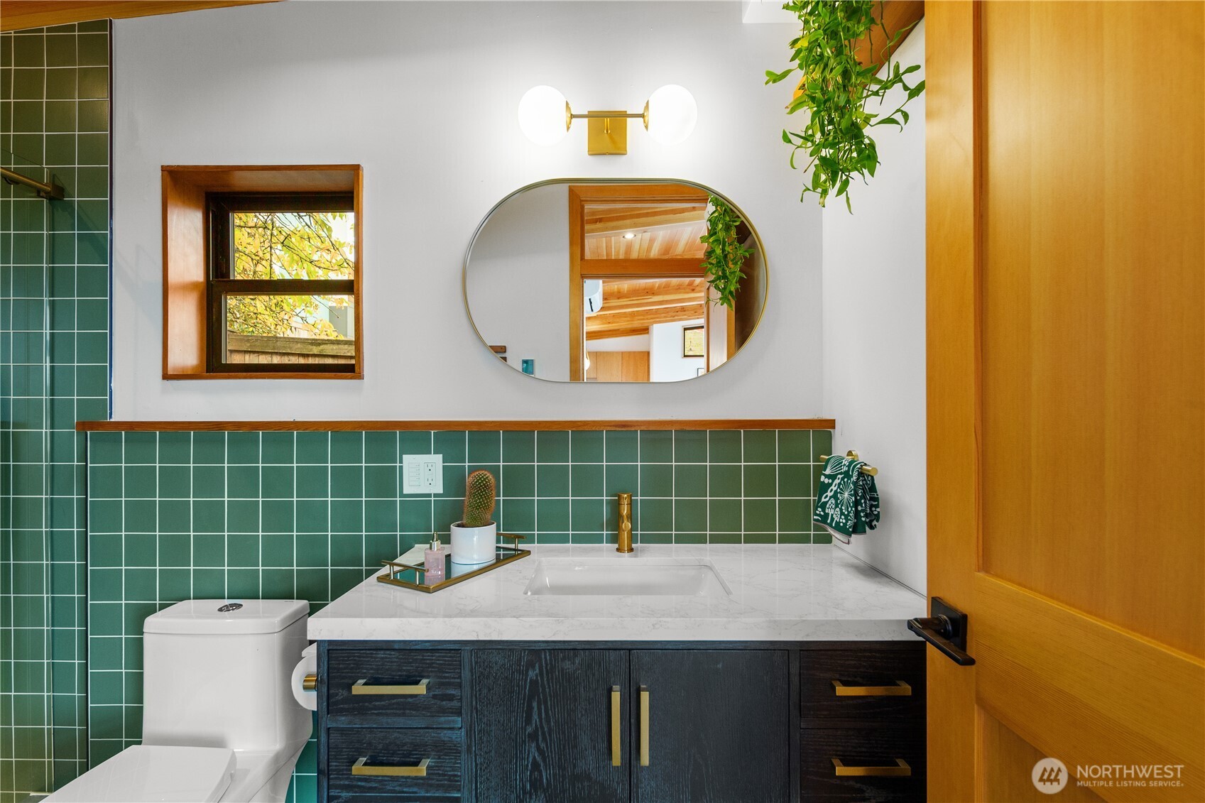 328 Northeast 55th Street Seattle, WA 98105 - Photo 15 of 35 a bathroom with a toilet a sink and mirror