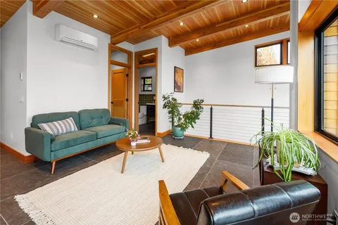 a living room with furniture and a potted plant