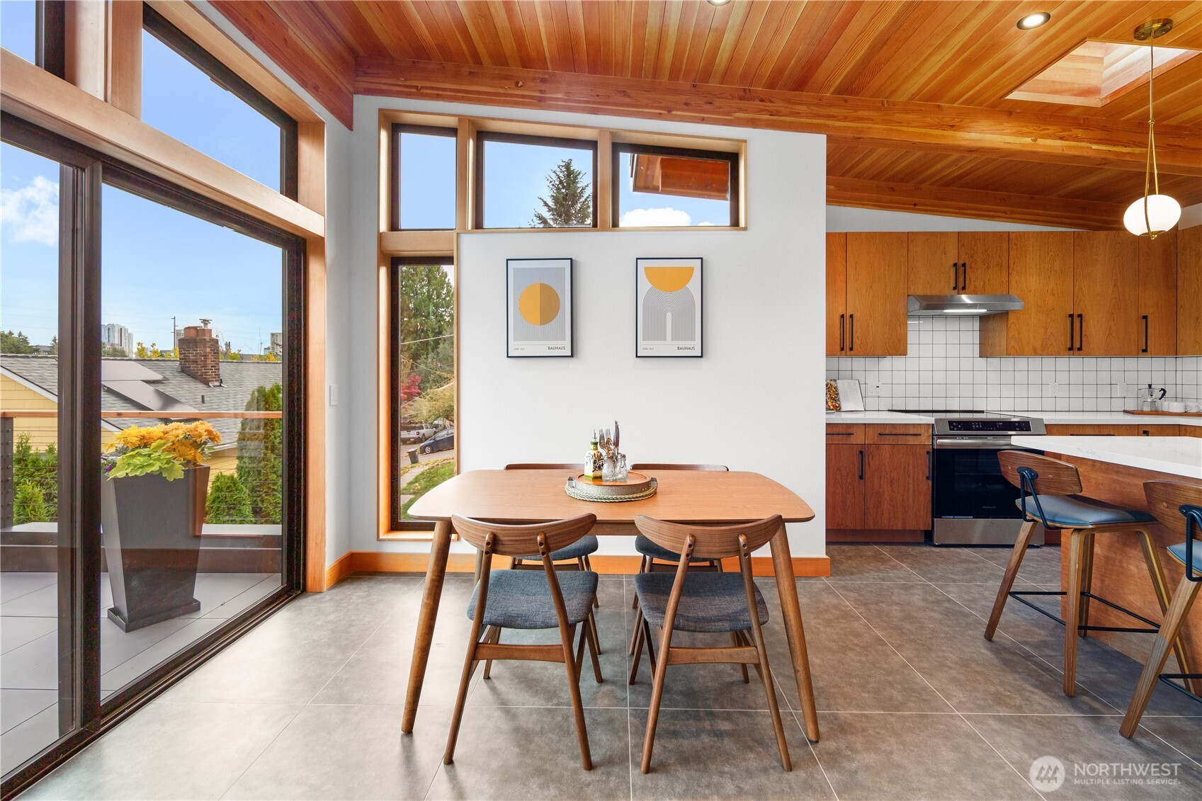 328 Northeast 55th Street Seattle, WA 98105 - Photo 4 of 35 a patio with a table and chairs and potted plants