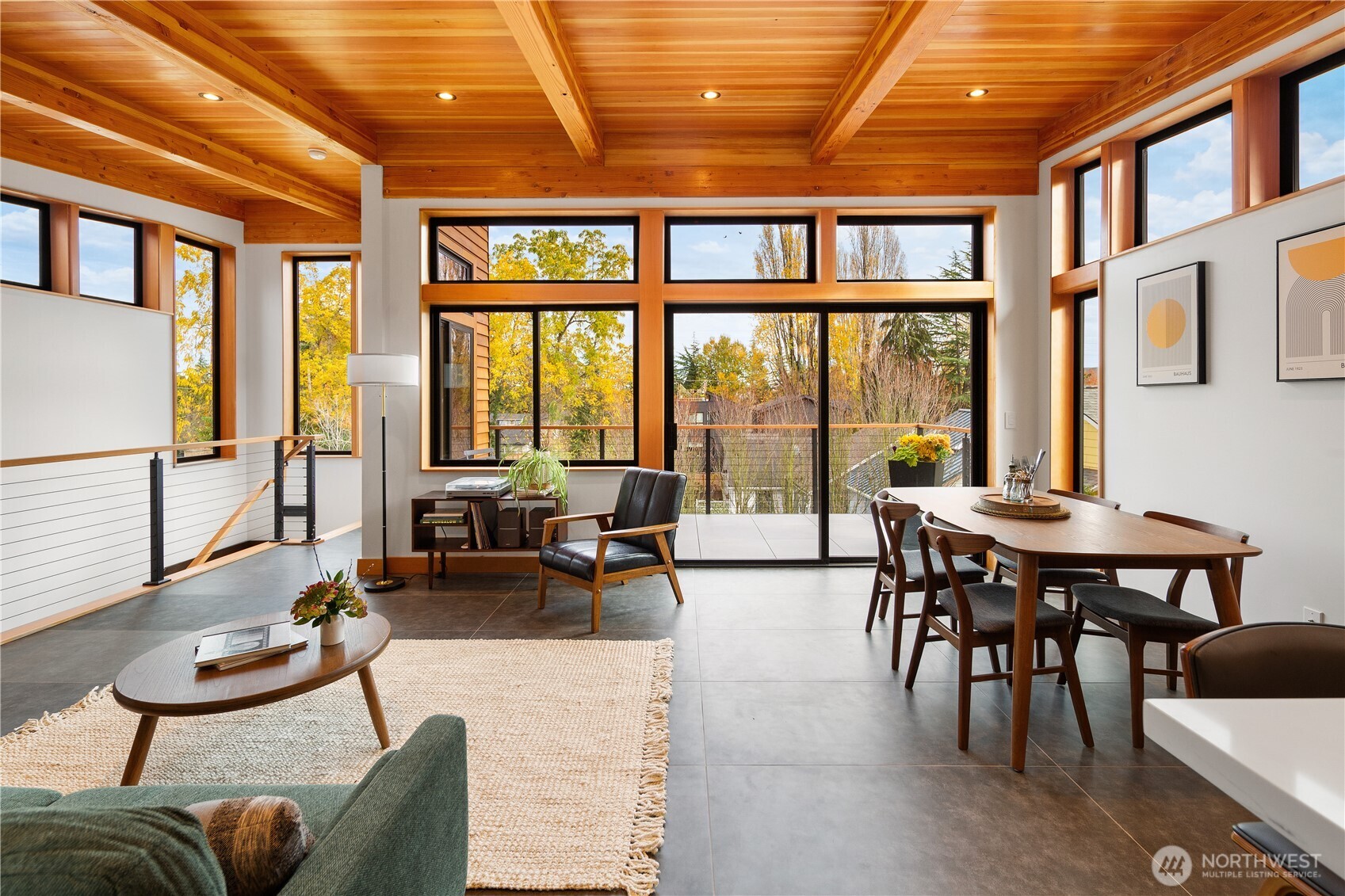 328 Northeast 55th Street Seattle, WA 98105 - Photo 6 of 35 a living room with furniture a wooden floor and floor to ceiling windows