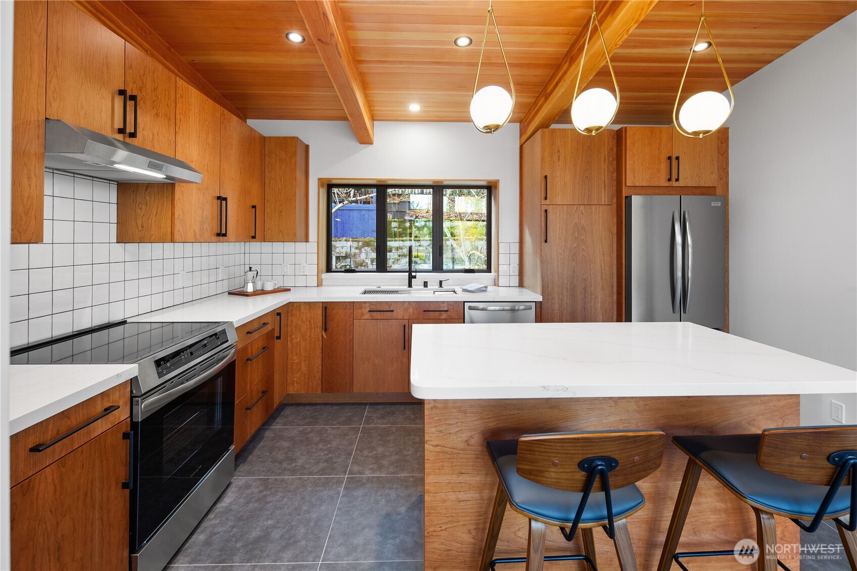 328 Northeast 55th Street Seattle, WA 98105 - Photo 9 of 35 a kitchen with a table chairs sink and cabinets