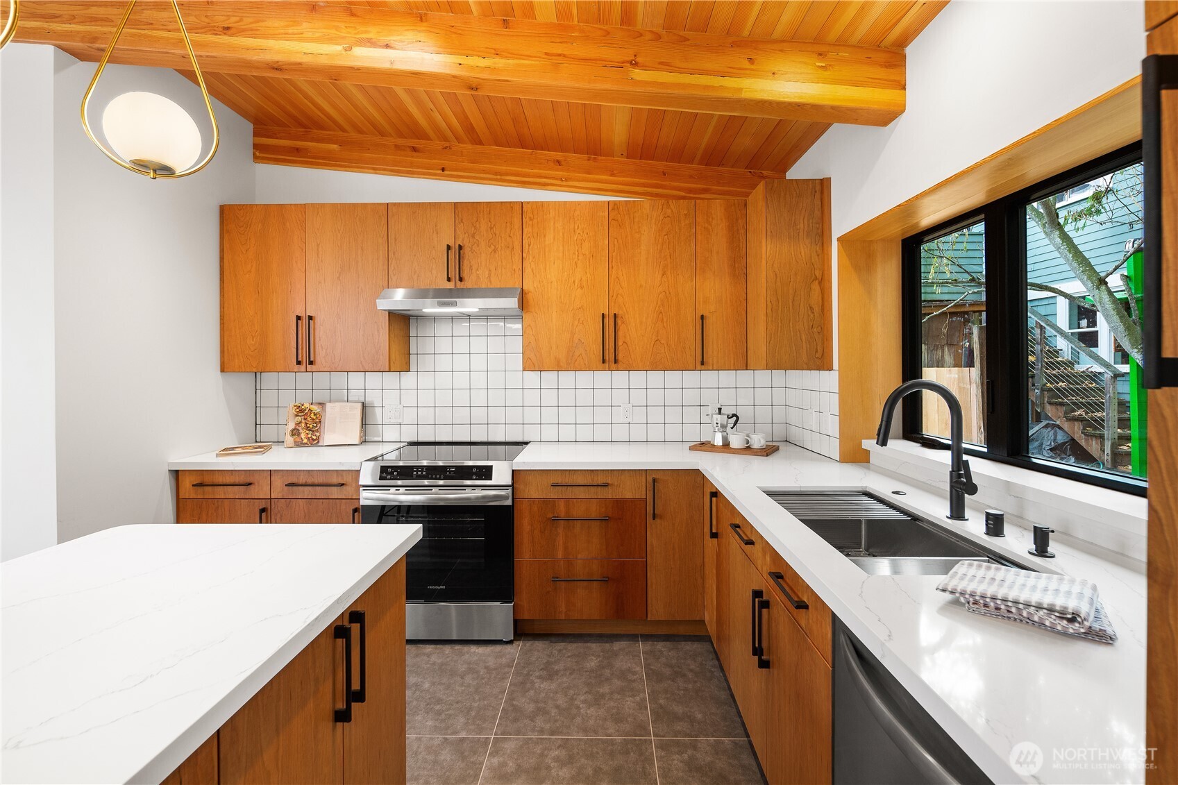 328 Northeast 55th Street Seattle, WA 98105 - Photo 10 of 35 a kitchen with a stove sink and cabinets