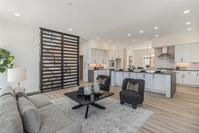 a living room with furniture and kitchen view