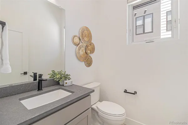 a bathroom with a sink a toilet and mirror