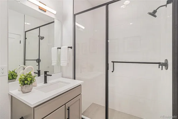 a bathroom with a sink a mirror and a shower