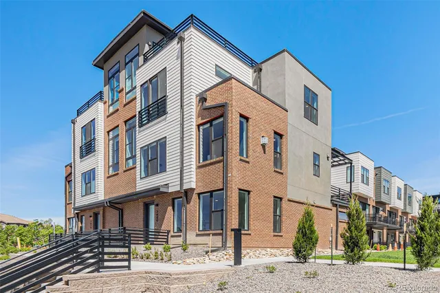 a front view of a residential apartment building with a street