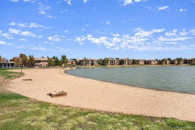 a view of a lake with houses in the back