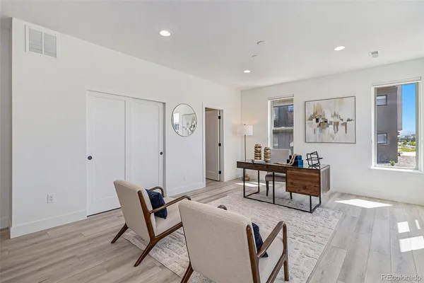 a view of a livingroom with furniture and a dining table
