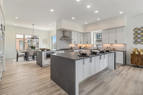 a kitchen with granite countertop a sink cabinets and wooden floor