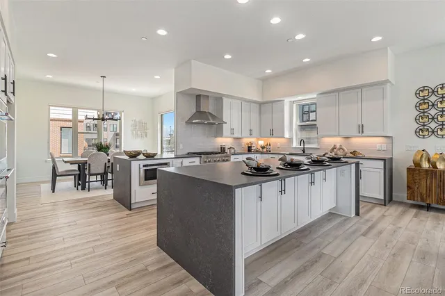 a kitchen with granite countertop a sink cabinets and wooden floor