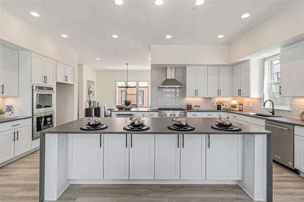 a kitchen with stainless steel appliances kitchen island granite countertop a sink and cabinets