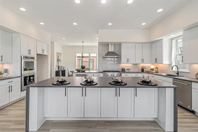 a kitchen with stainless steel appliances kitchen island granite countertop a sink and cabinets
