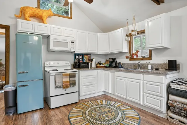 a kitchen with a white stove top oven and cabinets