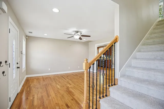 a view of an empty room with a ceiling fan