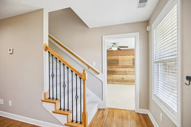 a view of entryway and hall with a ceiling fan