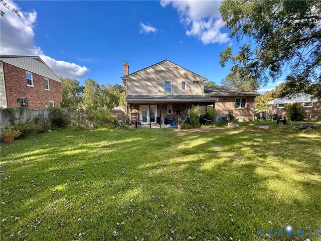 a view of a house with a yard and sitting area
