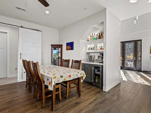 a view of a dining room with furniture and wooden floor