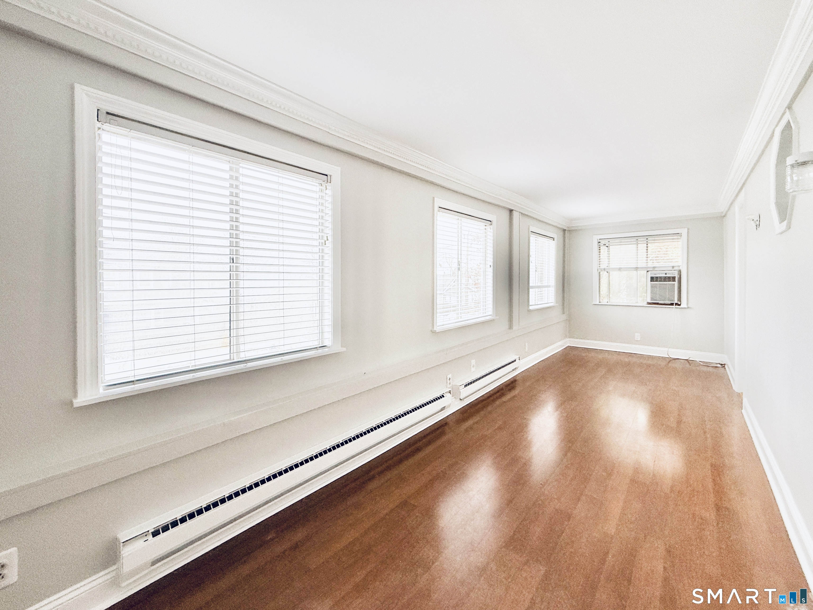23 Houston Terrace Stamford, CT 06902 - Photo 6 of 16 a view of an empty room with wooden floor and a window