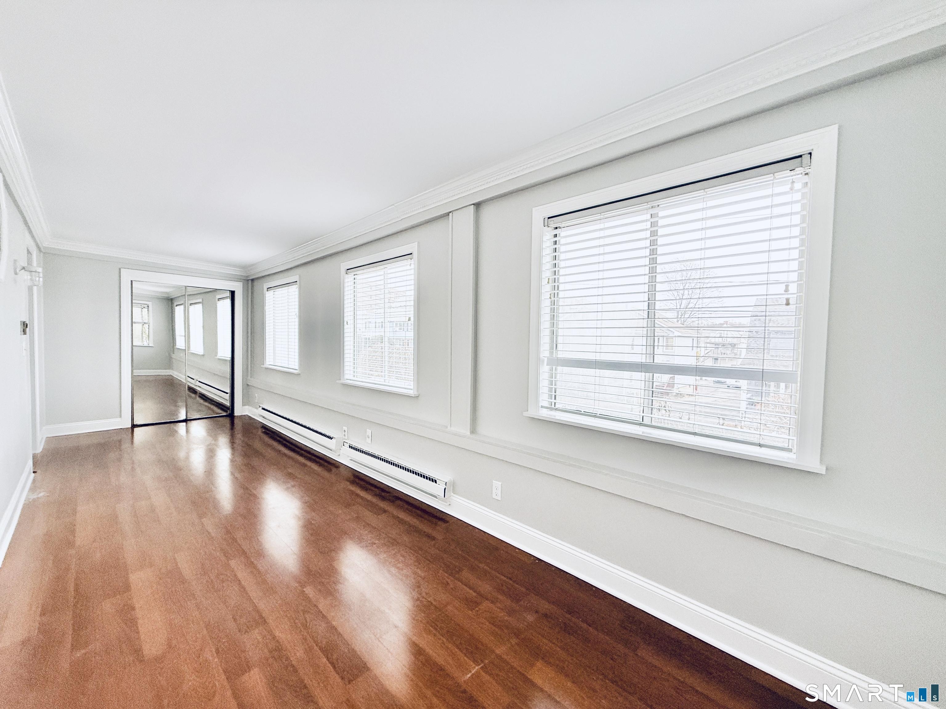 23 Houston Terrace Stamford, CT 06902 - Photo 7 of 16 a view of an empty room with wooden floor and a window