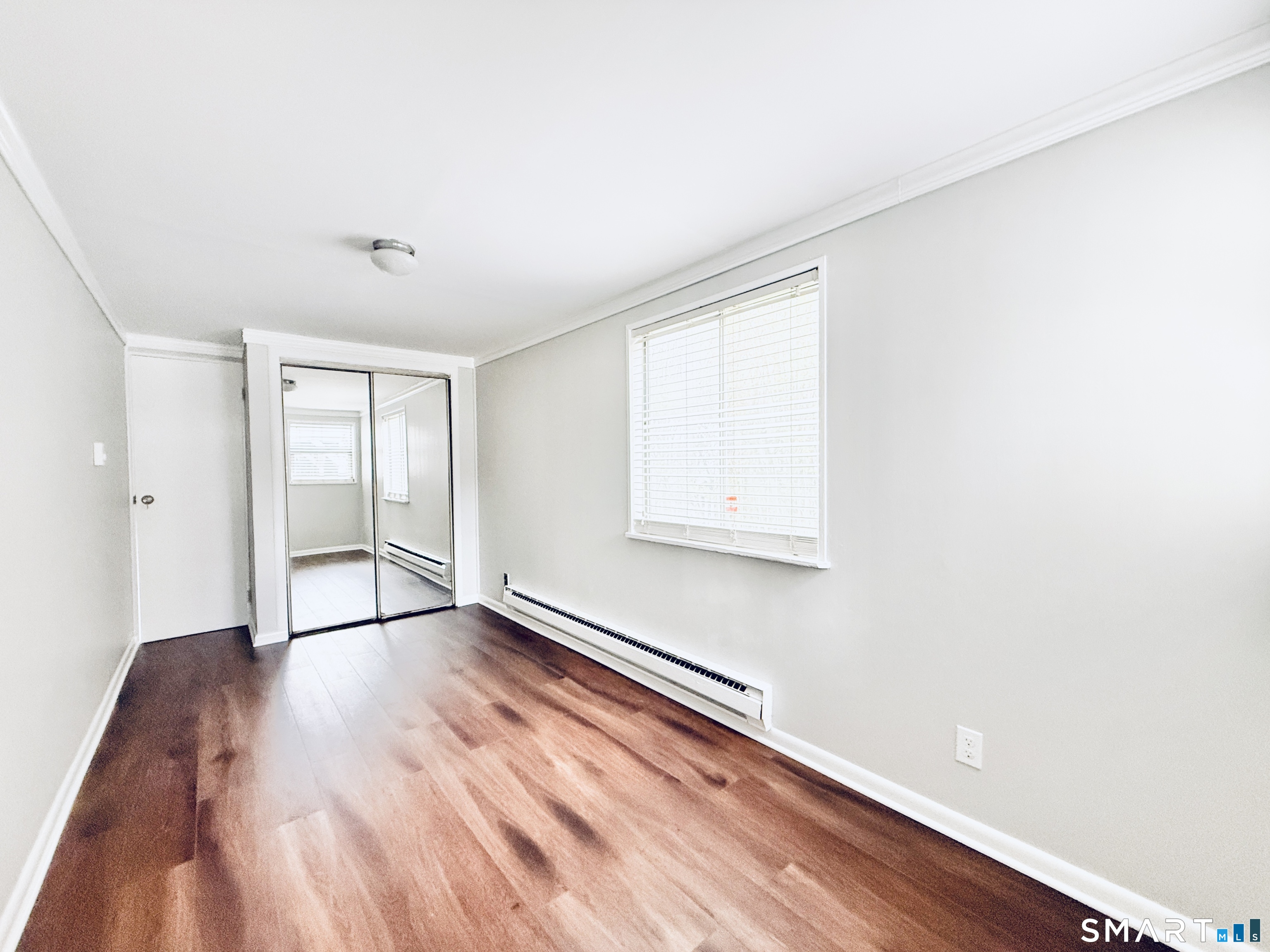 23 Houston Terrace Stamford, CT 06902 - Photo 8 of 16 an empty room with wooden floor and windows