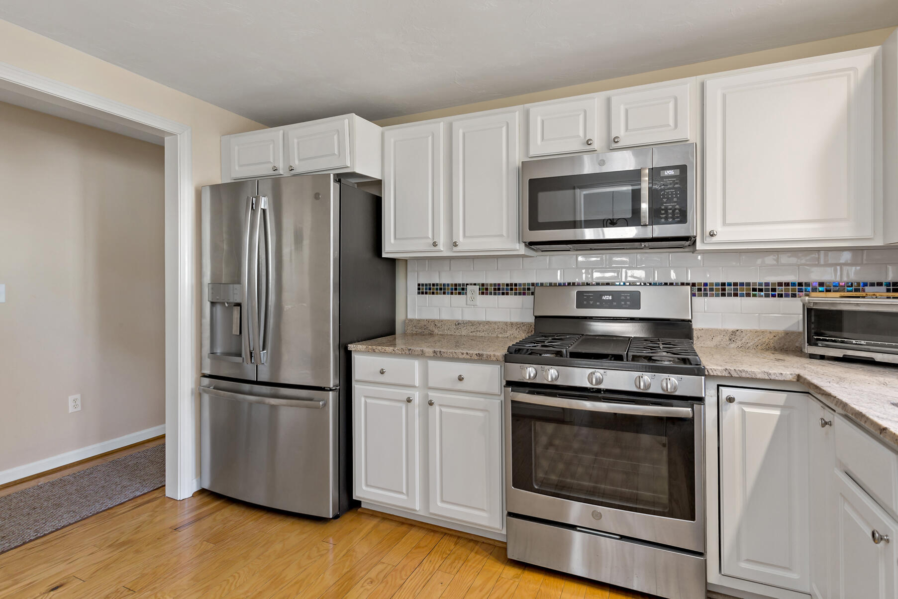 30 Bonwood Drive Mashpee, MA 02649 - Photo 5 of 23 a kitchen with cabinets stainless steel appliances and wooden floor
