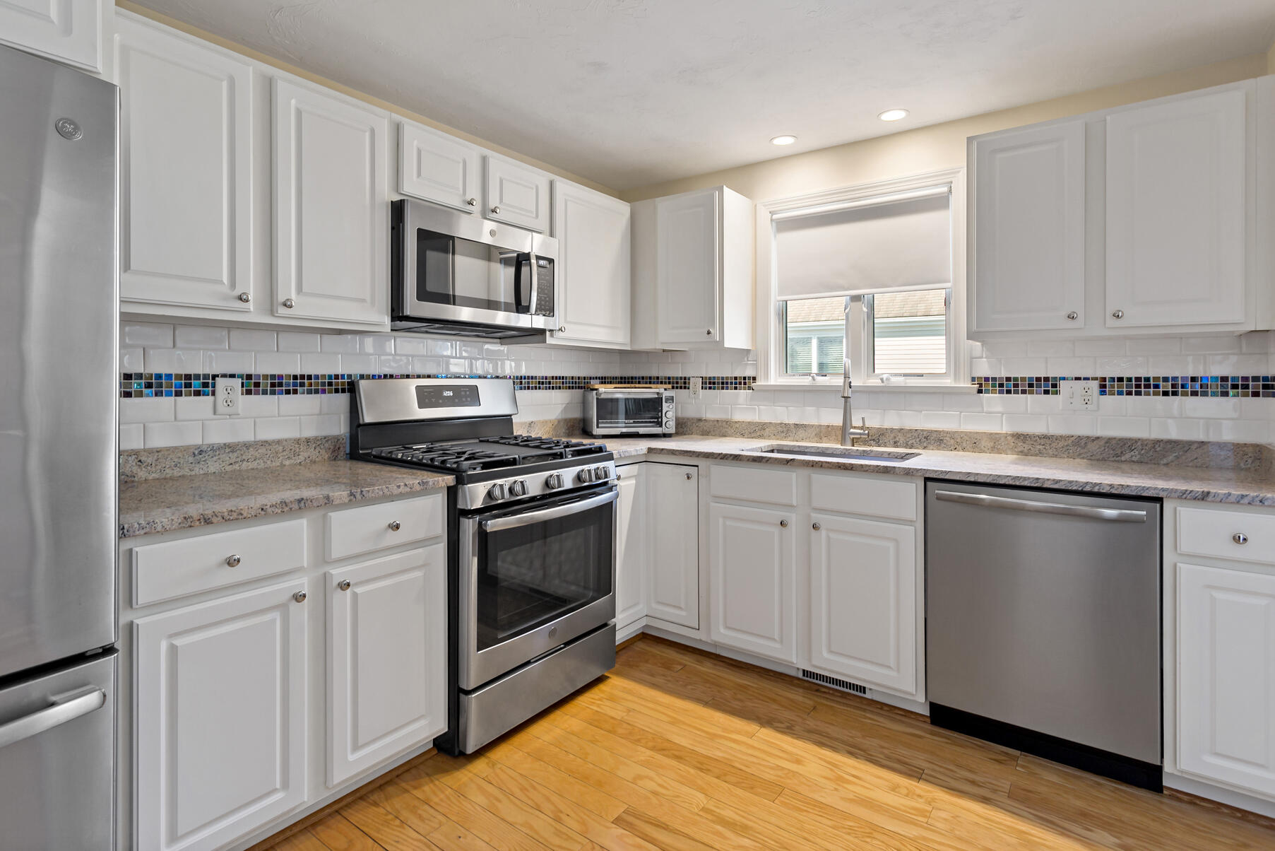 30 Bonwood Drive Mashpee, MA 02649 - Photo 7 of 23 a kitchen with stainless steel appliances granite countertop a sink a stove a microwave and cabinets