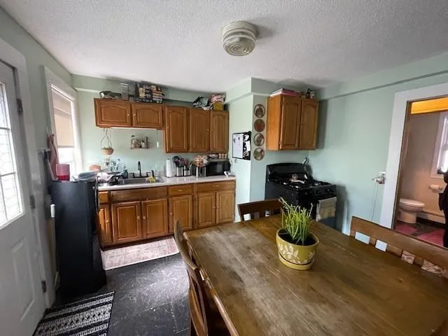 a kitchen with a refrigerator and a stove top oven