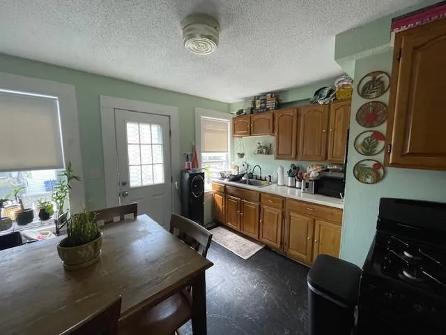 a kitchen with a table chairs stove and cabinets