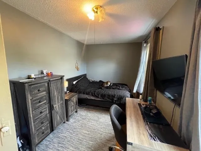 a bedroom with furniture and a flat screen tv