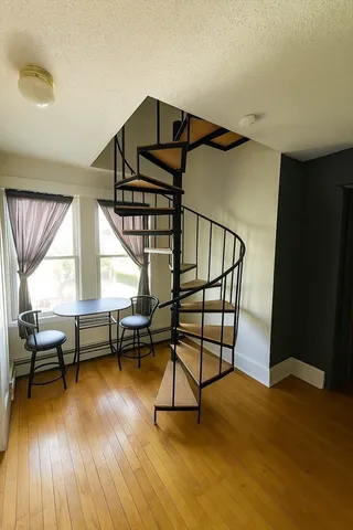 a view of entryway dining room and hall with wooden floor