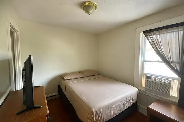 a bedroom with a bed and a window