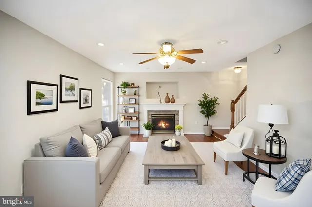 a living room with furniture a chandelier and a fireplace