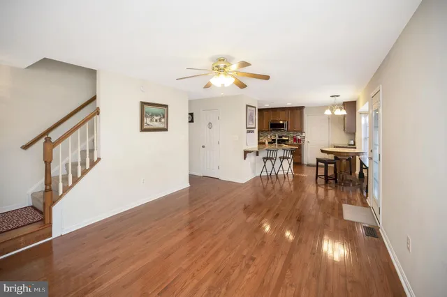 a view of a living room and dining room with wooden floor