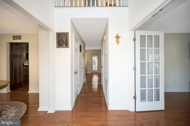 a view of a livingroom with wooden floor and furniture