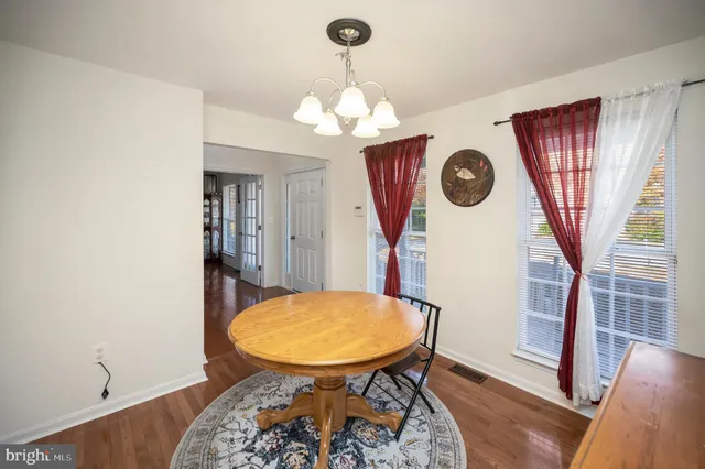 a view of a room with furniture and wooden floor