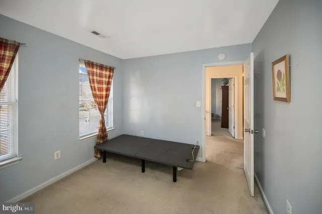 a room with furniture a rug and white walls