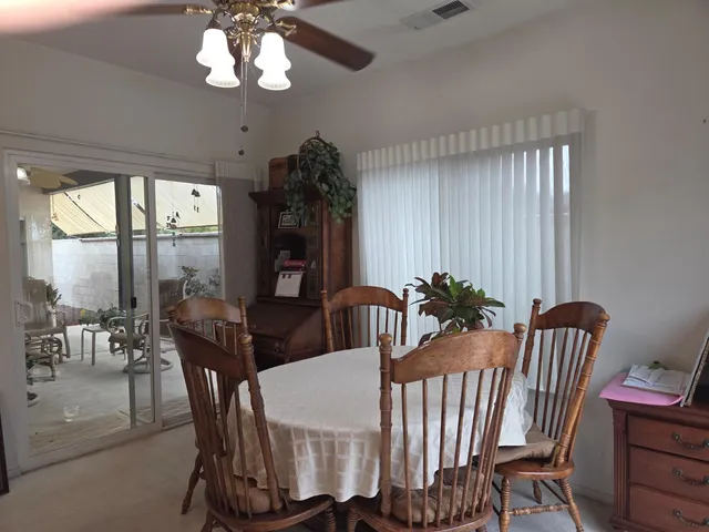 a living room with furniture and flowers