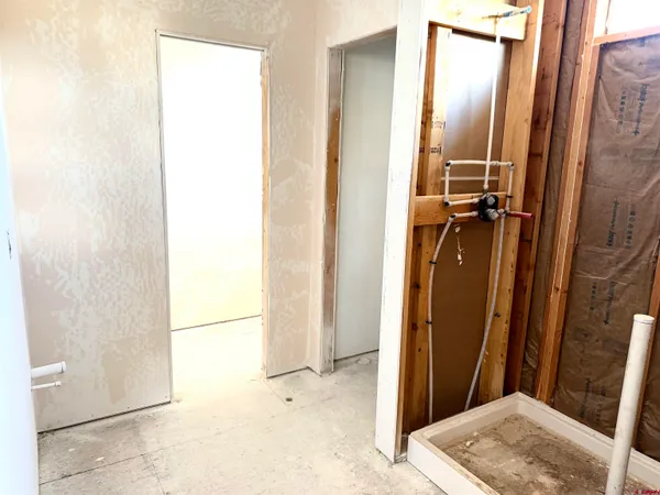 an empty room with wooden floor and window