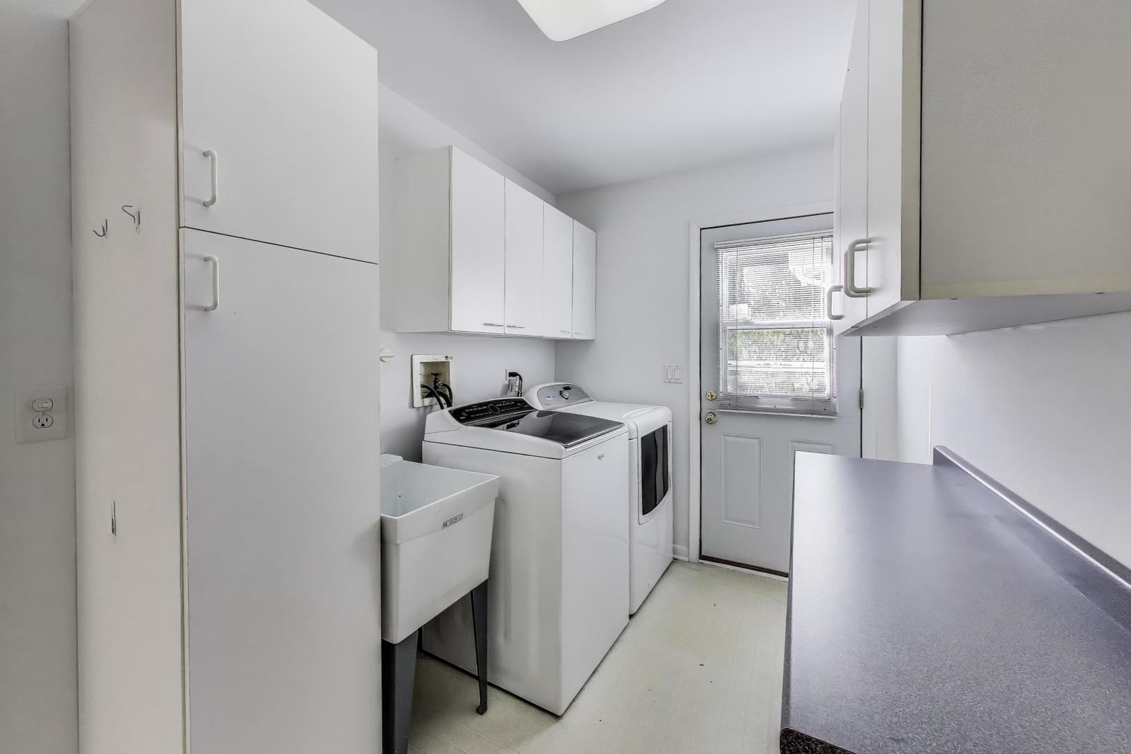 1903 Sheridan Road Buffalo Grove, IL 60089 - Photo 13 of 33 a kitchen with white cabinets and white appliances