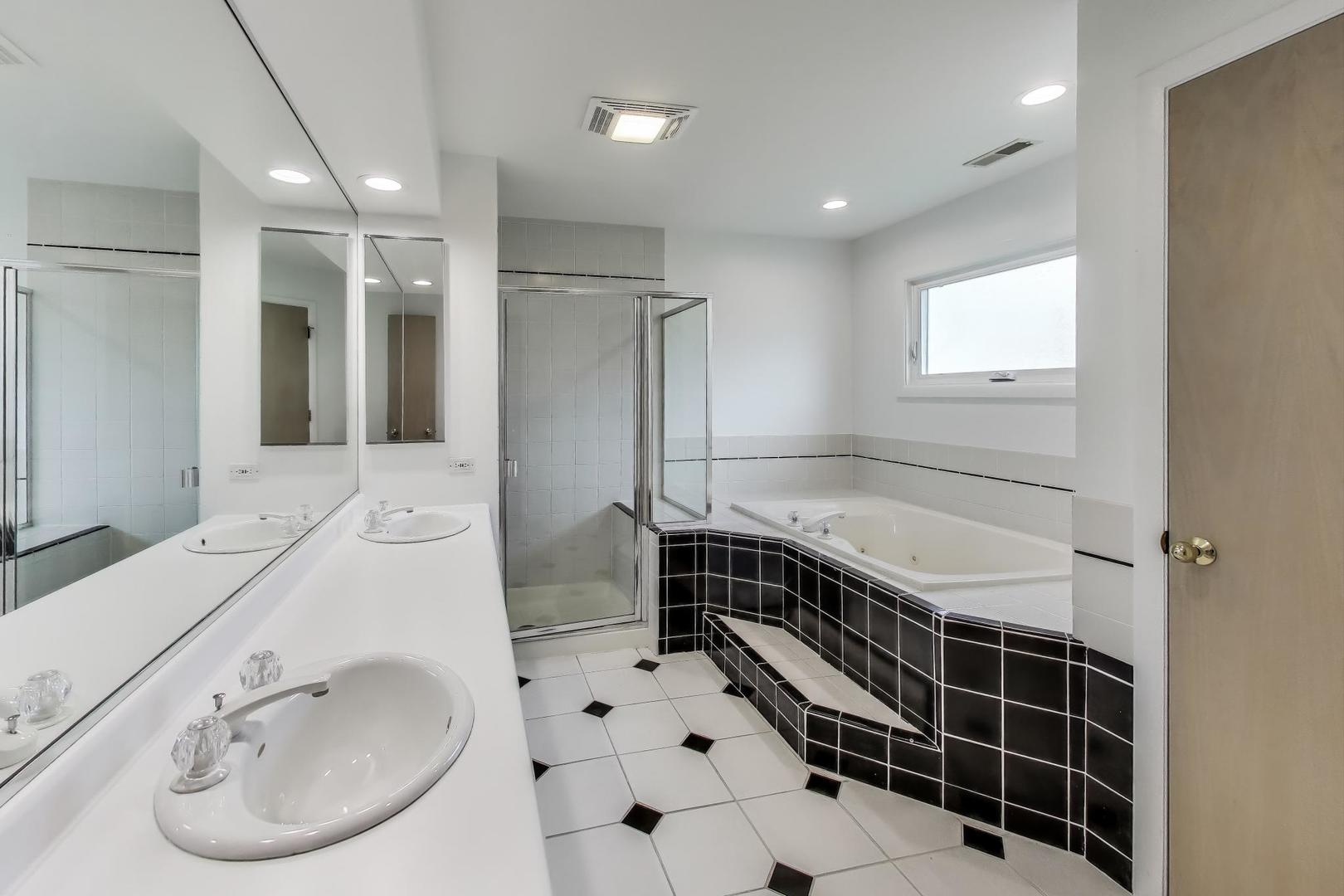 1903 Sheridan Road Buffalo Grove, IL 60089 - Photo 16 of 33 a bathroom with a tub sink and mirror