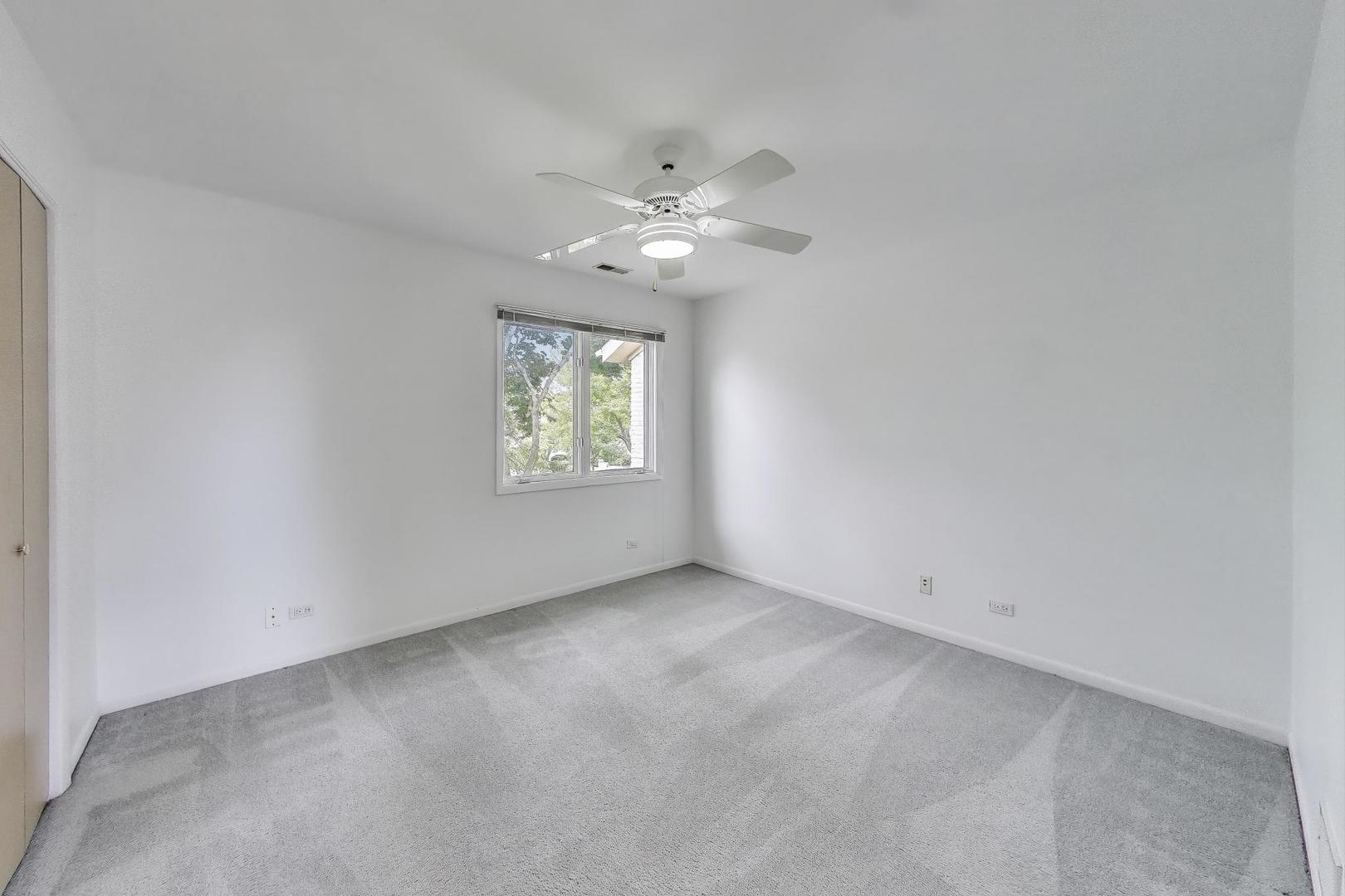 1903 Sheridan Road Buffalo Grove, IL 60089 - Photo 17 of 33 an empty room with a window and a fan