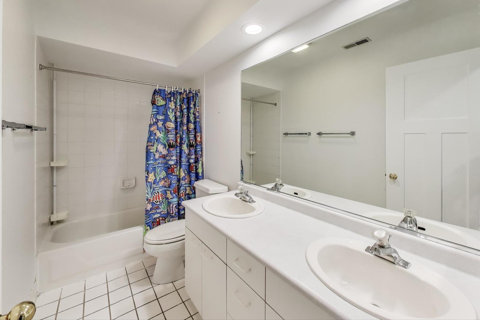 1903 Sheridan Road Buffalo Grove, IL 60089 - Photo 19 of 33 a bathroom with a sink toilet and shower