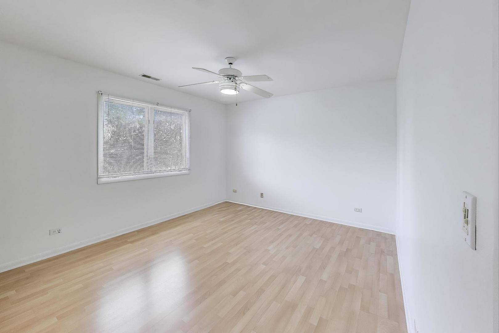1903 Sheridan Road Buffalo Grove, IL 60089 - Photo 20 of 33 wooden floor in an empty room with a window