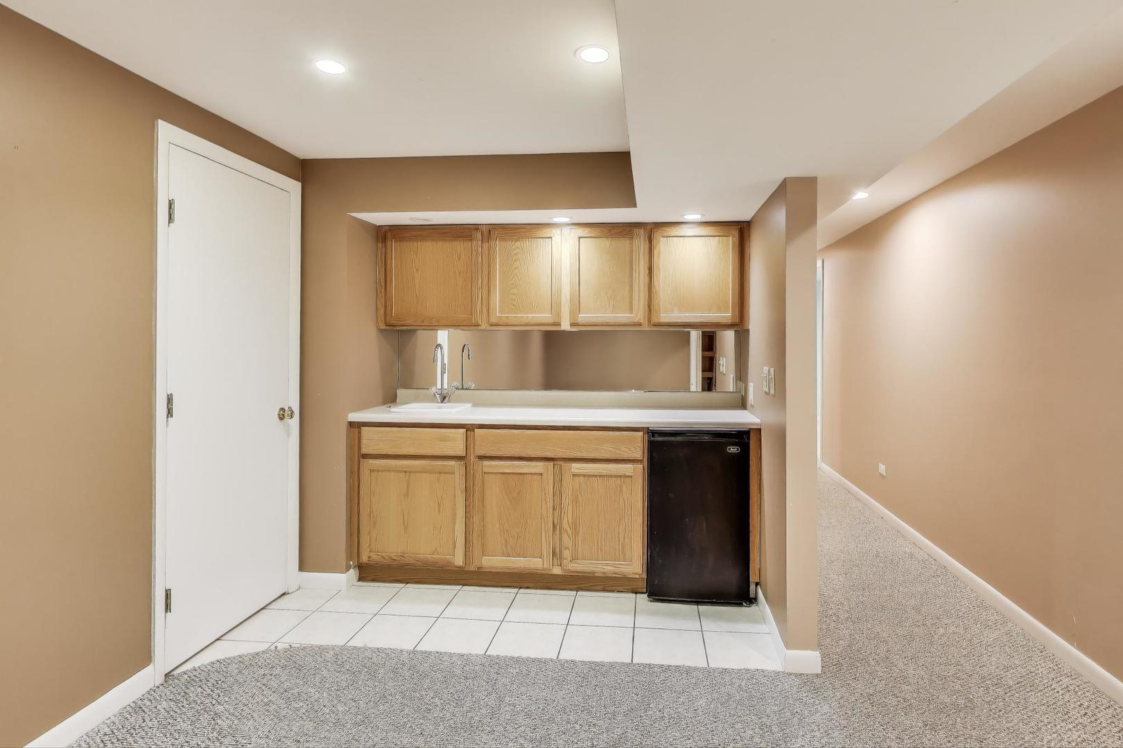 1903 Sheridan Road Buffalo Grove, IL 60089 - Photo 24 of 33 a kitchen with stainless steel appliances granite countertop a sink and a stove top oven