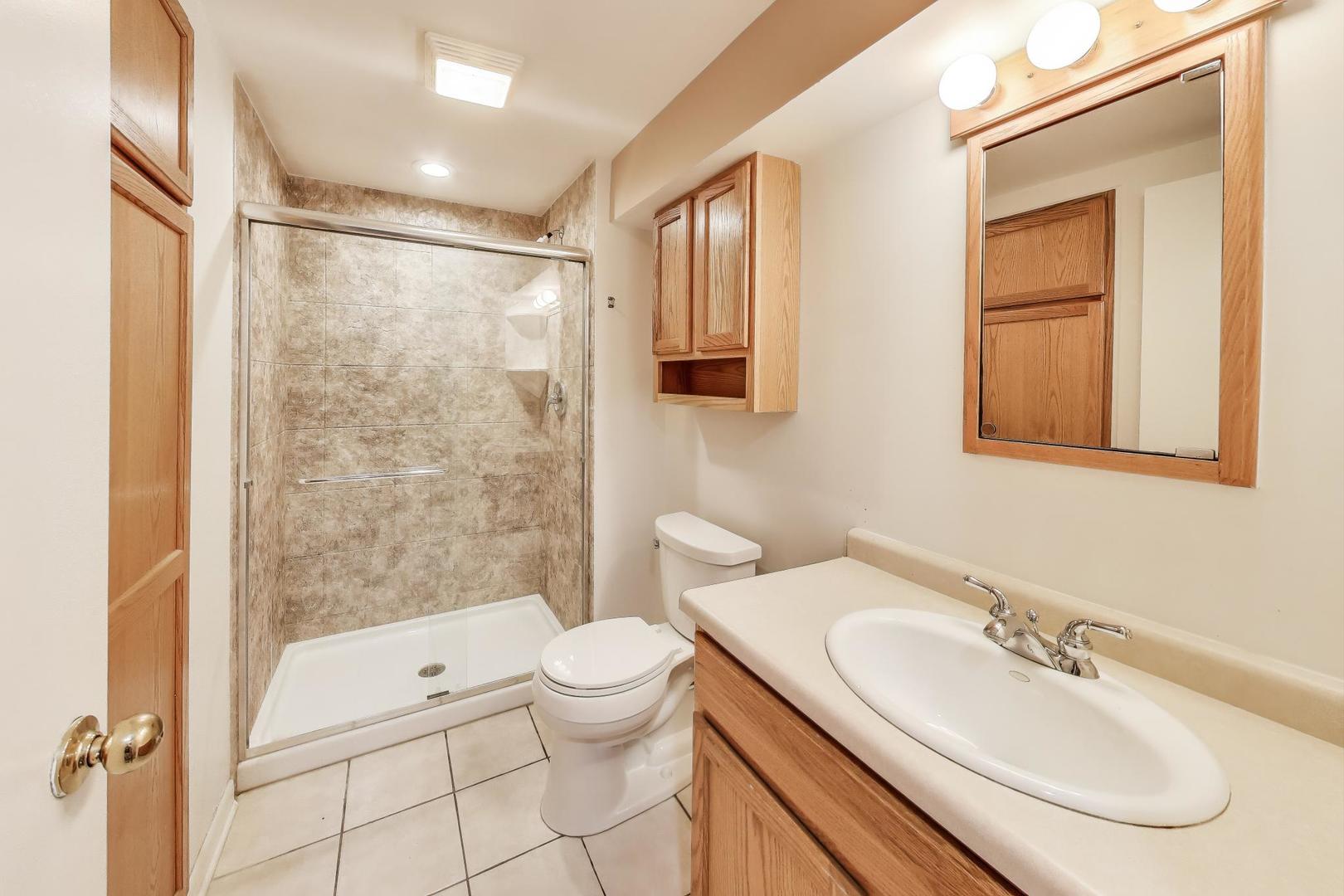 1903 Sheridan Road Buffalo Grove, IL 60089 - Photo 27 of 33 a bathroom with a sink a toilet and shower