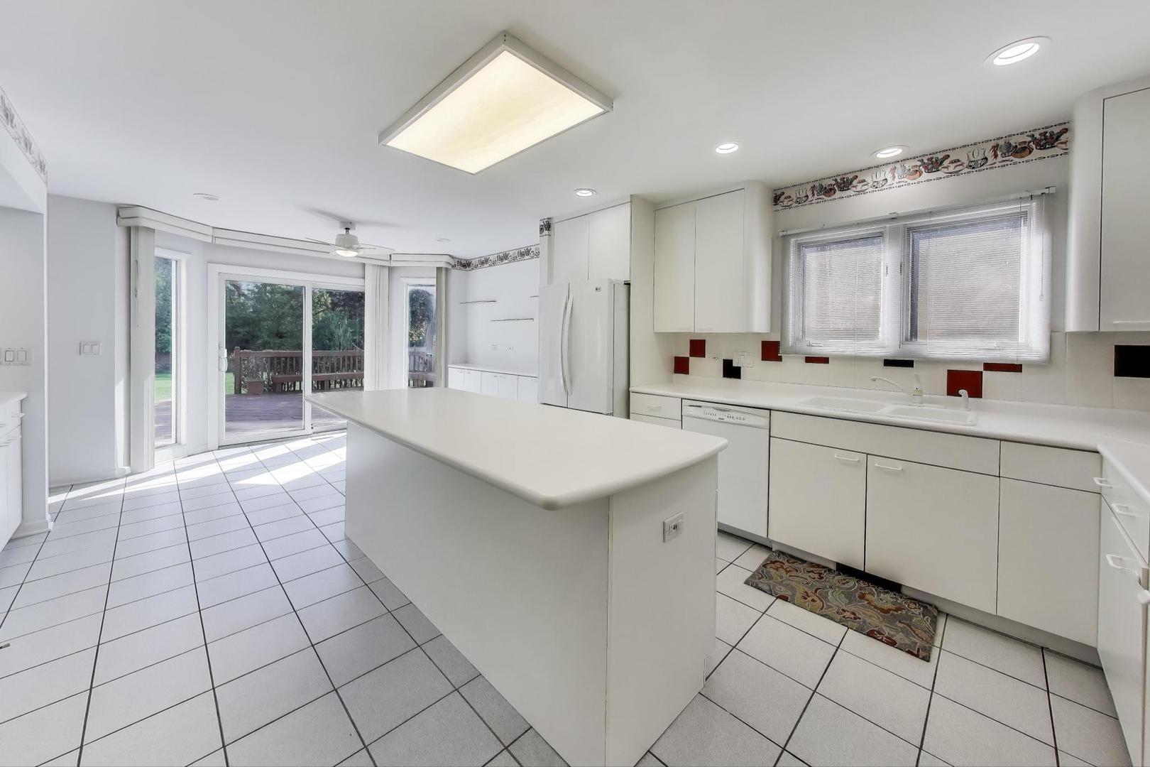 1903 Sheridan Road Buffalo Grove, IL 60089 - Photo 7 of 33 a large white kitchen with a sink and cabinets