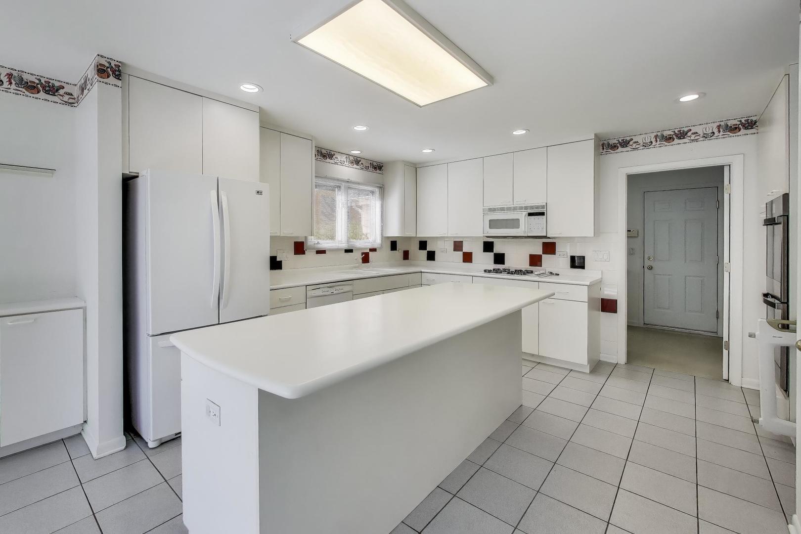 1903 Sheridan Road Buffalo Grove, IL 60089 - Photo 8 of 33 a kitchen with stainless steel appliances a sink stove and cabinets