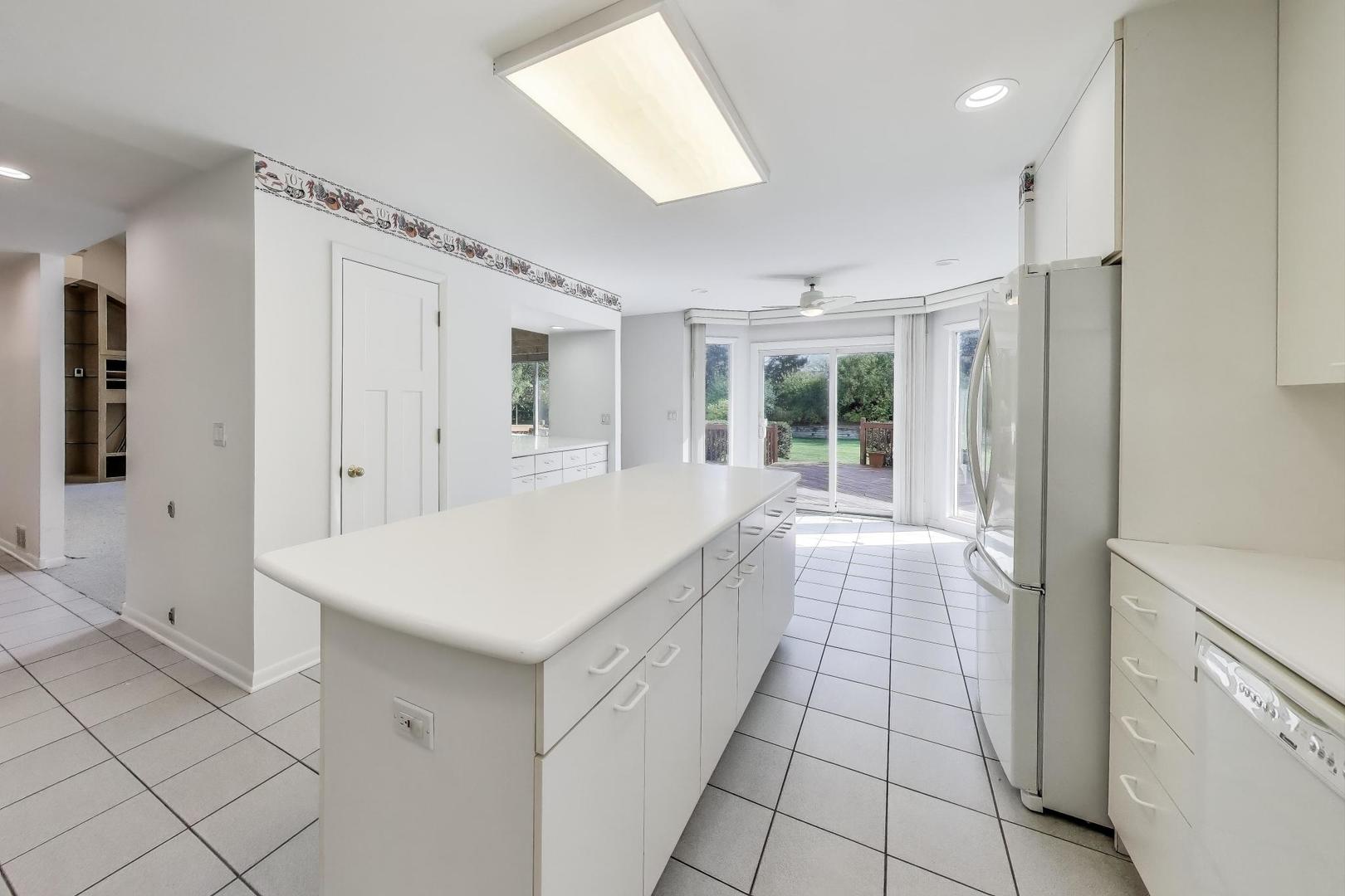 1903 Sheridan Road Buffalo Grove, IL 60089 - Photo 9 of 33 a bathroom with a sink a mirror and a shower