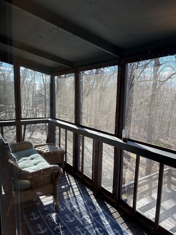 150 West Wrentham Road Cumberland, RI 02864 - Photo 12 of 38 a view of a porch with furniture and wooden floor
